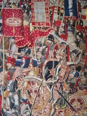 Le roi Alphonse V et son étendard à la devise de la roue de moulin lors de l’expédition contre Arzila en 1471. Tapisserie de Pastrana.